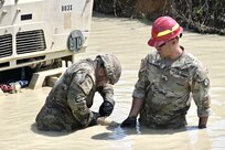 Soldiers with Delta Company, 128th Brigade Support Battalion, 2nd Infantry Brigade Combat Team, 28th Infantry Division conduct vehicle extraction training in a mire pit at Fort Indiantown Gap, Pa., on Aug. 11, 2024, during their annual training. (U.S. Army National Guard photo by Spc. Jessica Barb)