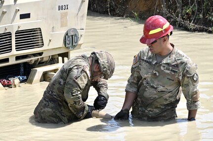 Soldiers with Delta Company, 128th Brigade Support Battalion, 2nd Infantry Brigade Combat Team, 28th Infantry Division conduct vehicle extraction training in a mire pit at Fort Indiantown Gap, Pa., on Aug. 11, 2024, during their annual training. (U.S. Army National Guard photo by Spc. Jessica Barb)