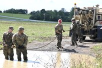 Soldiers with Delta Company, 128th Brigade Support Battalion, 2nd Infantry Brigade Combat Team, 28th Infantry Division conduct vehicle extraction training in a mire pit at Fort Indiantown Gap, Pa., on Aug. 11, 2024, during their annual training. (U.S. Army National Guard photo by Spc. Jessica Barb)