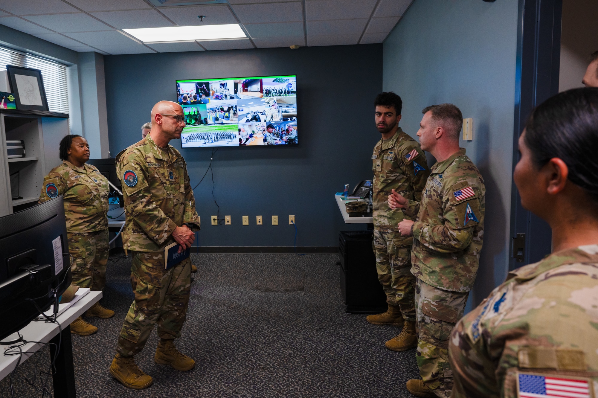 Chief Master Sergeant of the Space Force John F. Bentivegna listens to a brief from Capt. Samuel Aspiranti, 533rd Training Squadron Det 2 commander, at Keesler Air Force Base, Mississippi, Aug. 9, 2024.