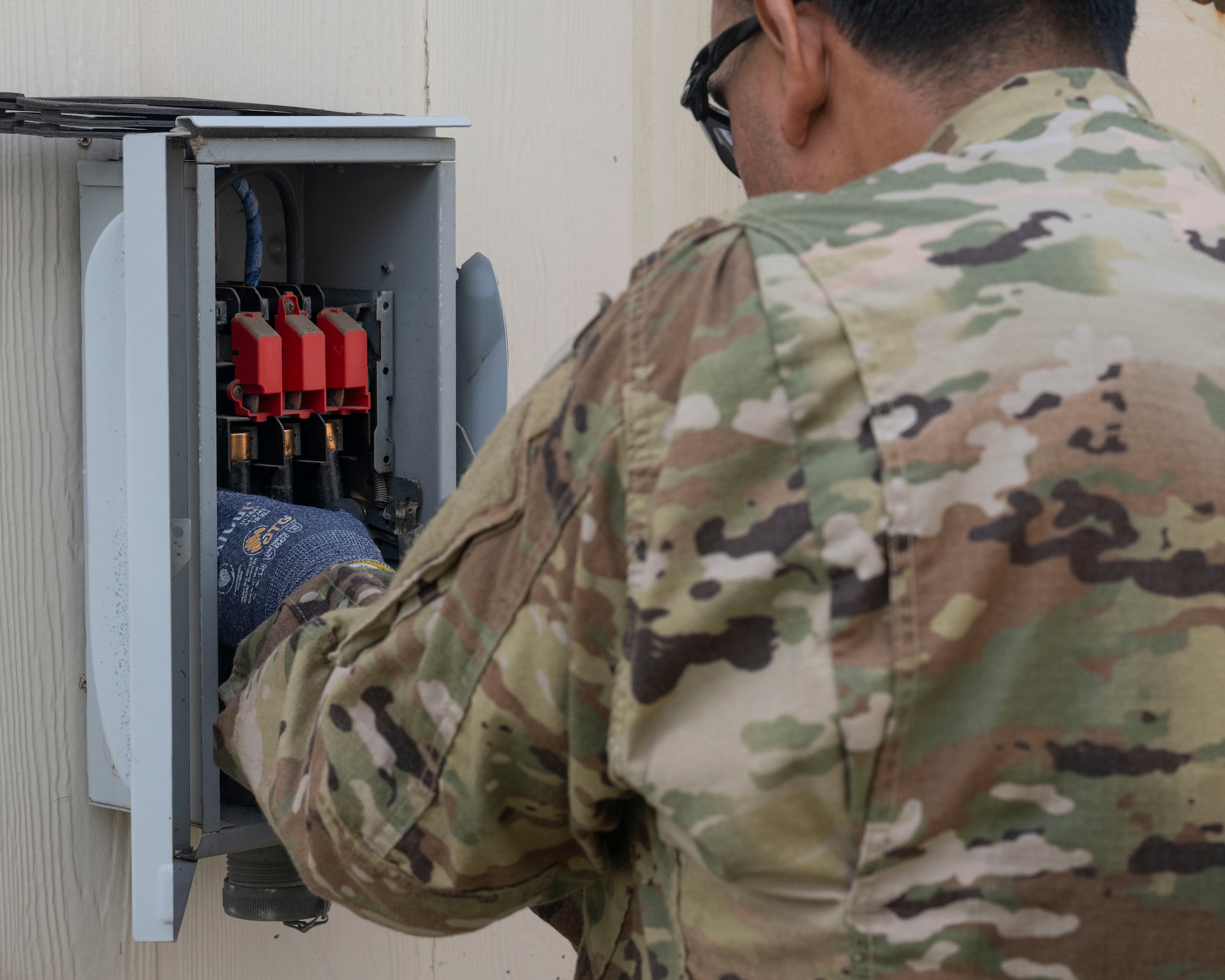 U.S. Air Force Staff Sgt. Javier Ruiz, 8th Civil Engineer Squadron heating ventilation, air conditioning and refrigeration journeyman, replaces old fuses at Kunsan Air Base, Republic of Korea.