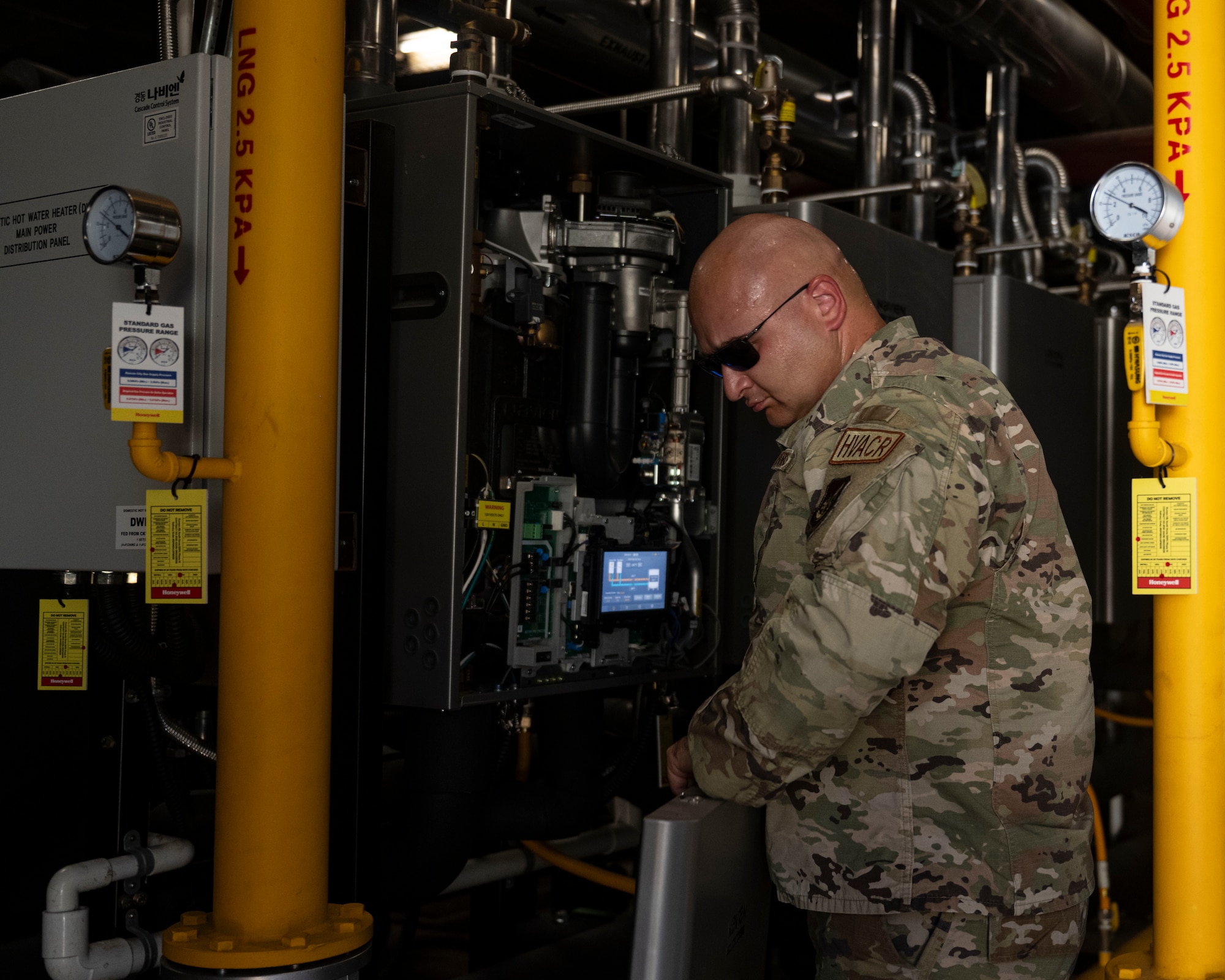 U.S. Air Force Master Sgt. Lyle Glatz, a heating, ventilation, air conditioning and refrigeration technician assigned to the 263rd Combat Communication Squadron, North Carolina Air National Guard, checks water systems of a chiller unit at Kunsan Air Base, Republic of Korea.