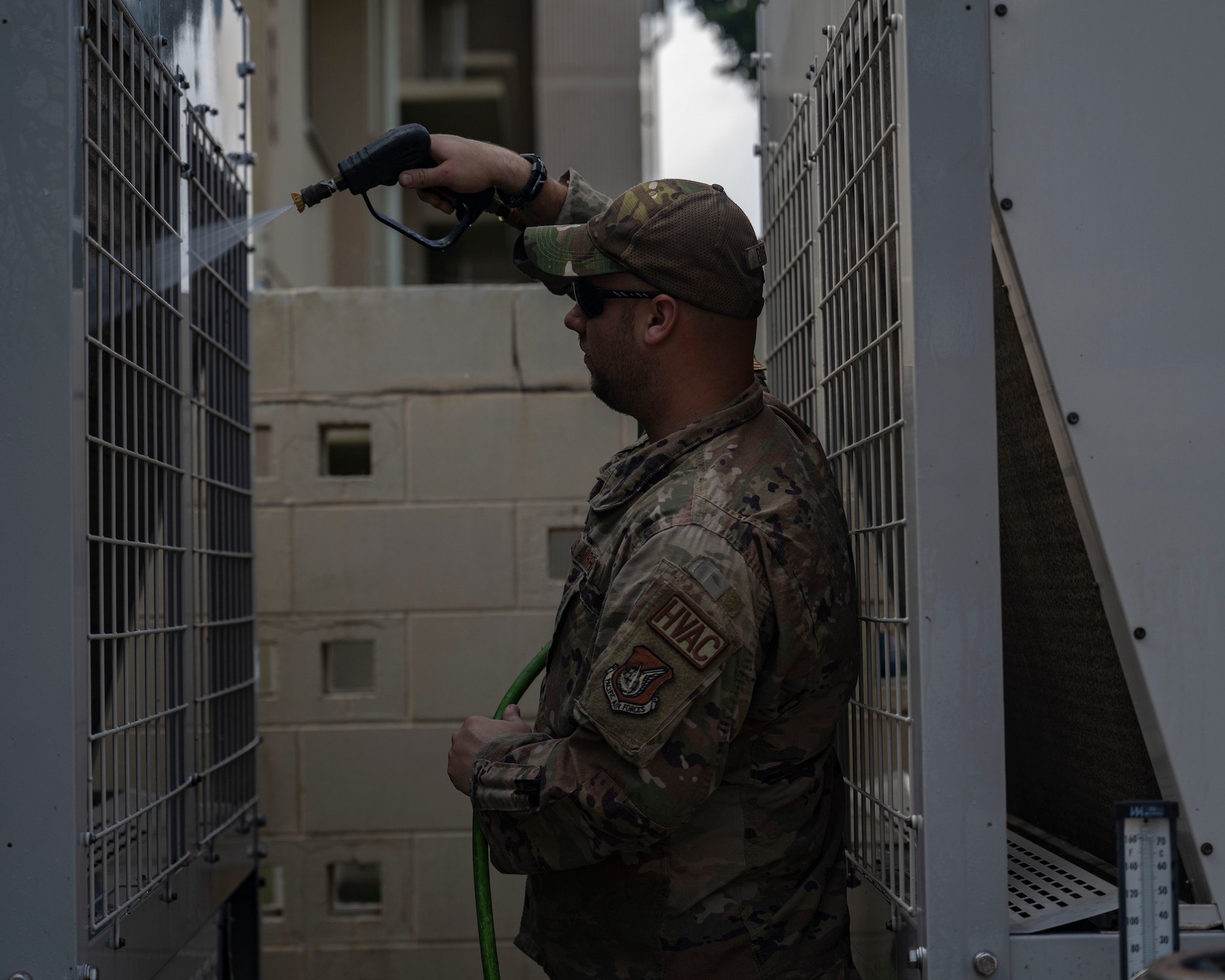 U.S. Air Force Staff Sgt. Justin Bosch, 8th Civil Engineer Squadron heating ventilation air conditioning and refrigeration technician, washes a chiller unit at Kunsan Air Base, Republic of Korea