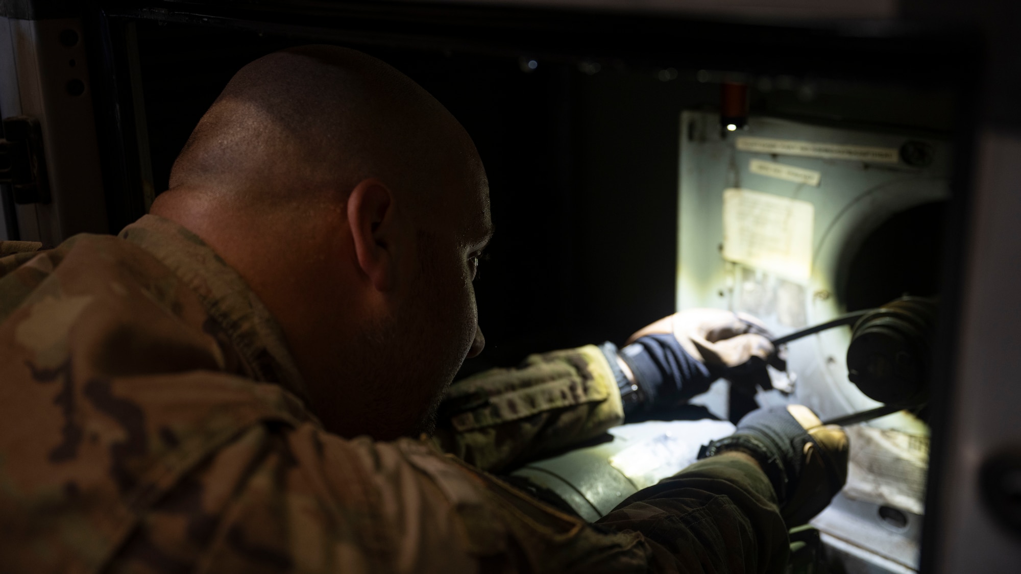 .S. Air Force Staff Sgt. Justin Bosch, 8th Civil Engineer Squadron heating, ventilation, air conditioning and refrigeration technician, fits a new belt on an AC unit at Kunsan Air Base, Republic of Korea.