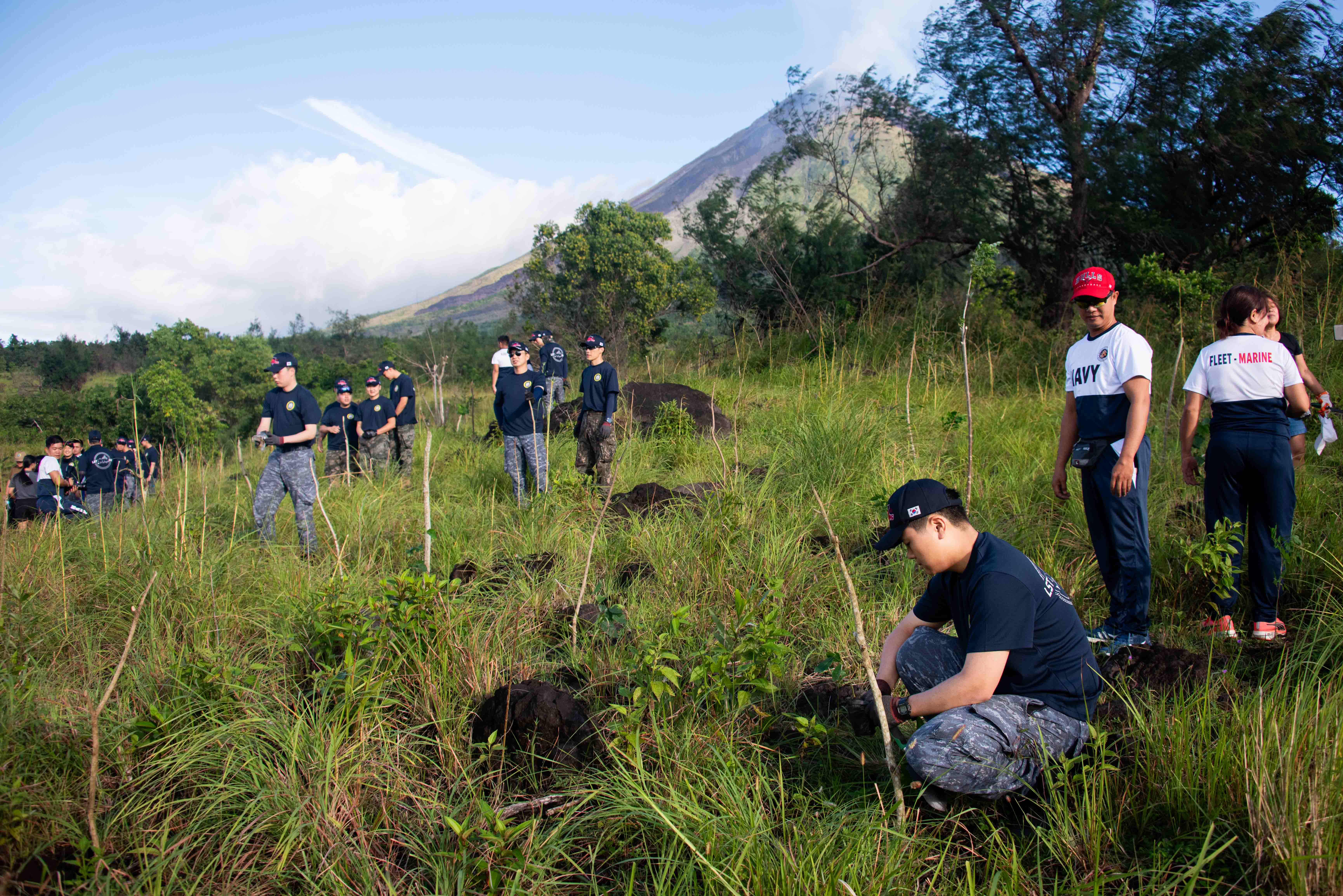 LEGAZPI, Philippines (Aug. 7, 2024) – Republic of Korea Navy sailors and Philippine Navy sailors plant saplings at the foot of the Mt. Mayon volcano during a tree planting community outreach event in support of Pacific partnership 2024-2 in Legazpi, Philippines, Aug. 7, 2024. Now in its 20th iteration, the Pacific Partnership series is the largest annual multinational humanitarian assistance and disaster relief preparedness mission conducted in the Indo-Pacific. Pacific Partnership works collaboratively with host and partner nations to enhance regional interoperability and disaster response capabilities, increase security and stability in the region, and foster new and enduring friendships in the Indo-Pacific. (U.S. Navy photo by Chief Mass Communication Specialist Raymond D. Diaz III/Released)