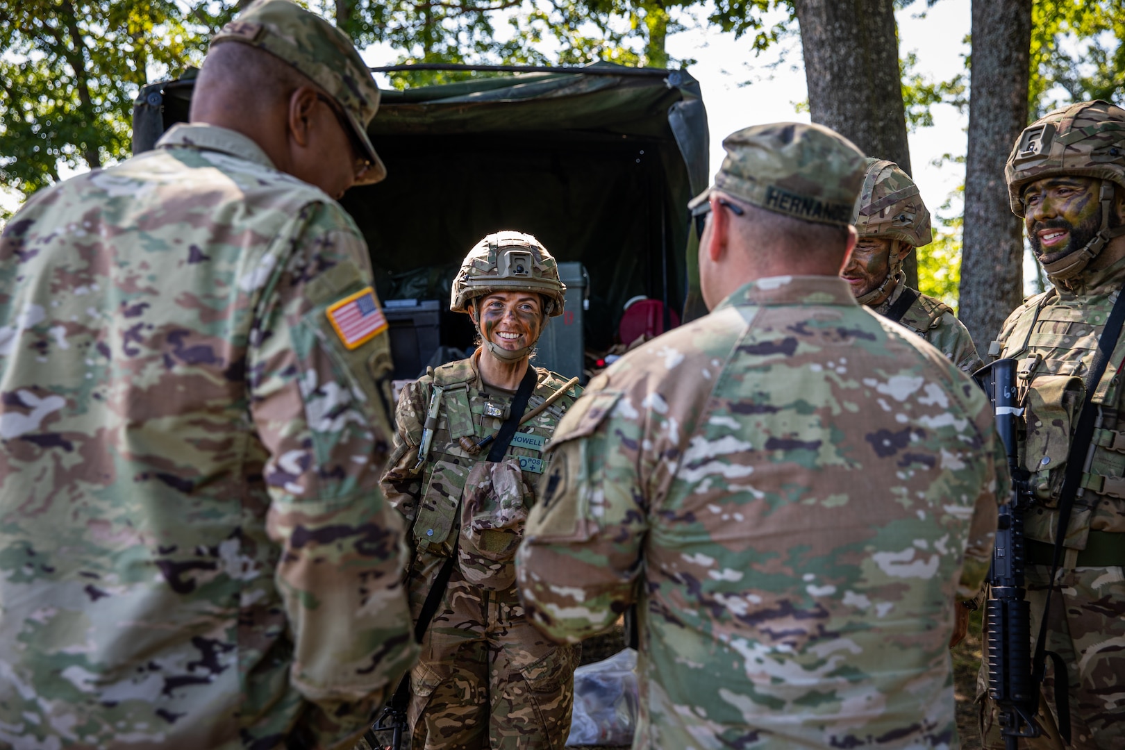 Command Sgt. Maj. John Hernandez, right foreground, state command sergeant major for Oklahoma, Oklahoma National Guard, and Command Sgt. Maj. William Russell III, left, senior enlisted leader for the adjutant general, Michigan National Guard, speak with members of the British Armed Forces during Exercise Northern Strike 2024 at Camp Grayling, Michigan, Aug. 12, 2024.