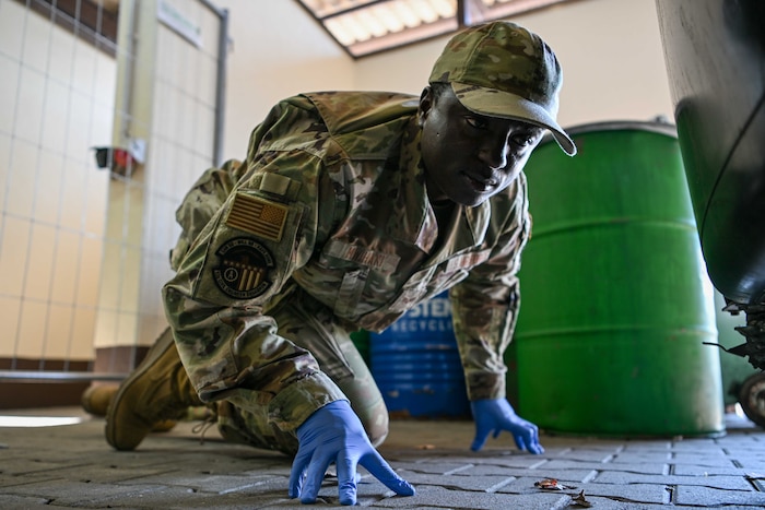 U.S. Air Force Senior Airman Malvin Mwihaki, 52nd Civil Engineer Squadron pest management journeymen, conducts a facility inspection at Spangdahlem Air Base, Germany, Aug. 13, 2024.