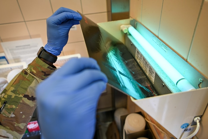 U.S. Air Force Senior Airman Malvin Mwihaki, 52nd Civil Engineer Squadron pest management journeymen, replaces a fly trap at Spangdahlem Air Base, Germany, Aug. 13, 2024.