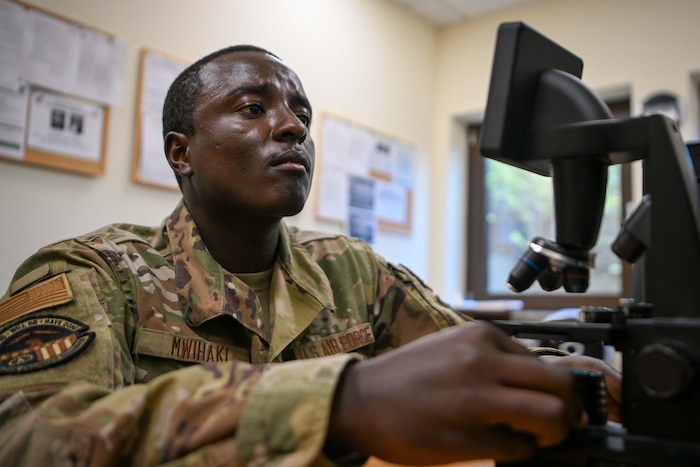 U.S. Air Force Senior Airman Malvin Mwihaki, 52nd Civil Engineer Squadron pest management journeymen, configures a microscope at Spangdahlem Air Base, Germany, Aug. 13, 2024.