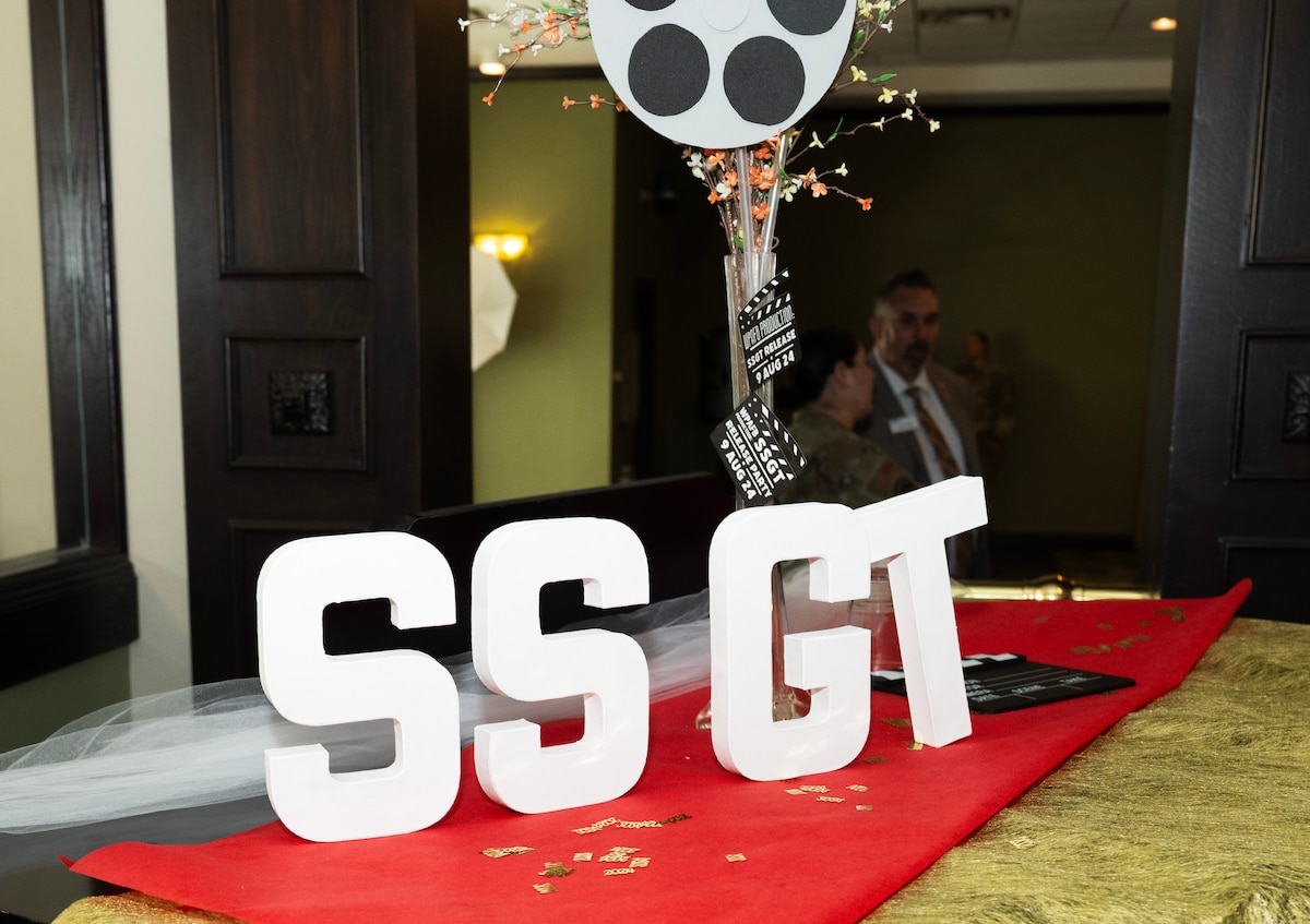 White cutouts of the letters S S G T stand on a red tablecloth.