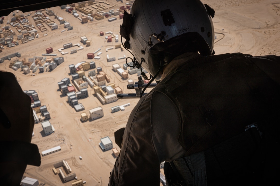 U.S. Marine Corps Lance Cpl. Jack Spackman, a Clermont, Florida native, helicopter crew chief with Marine Light Attack Helicopter Squadron (HMLA) 169, Marine Aircraft Group 39, 3rd Marine Aircraft Wing, overlooks Range 220 during a close air support exercise at Camp Wilson, Marine Corps Air-Ground Combat Center, Twentynine Palms, California, July 26, 2024. CAS is an offensive air support mission that is planned and executed to deliver firepower against selected enemy capabilities at a designated place and time. (U.S. Marine Corps photo by Lance Cpl. Iris Gantt)