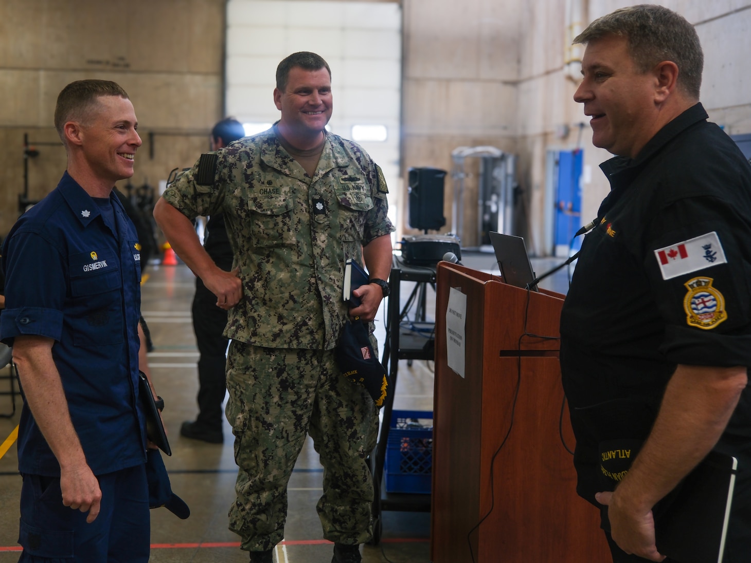 U.S. Coast Guard Cmdr. Brian Gismervik, commanding officer of Coast Guard Cutter Northland (WMEC 904), U.S. Navy Cmdr. Jeremiah Chase, commanding officer of Arleigh Burke-class guided-missile destroyer USS Delbert D. Black (DDG 119) and Royal Canadian navy Capt. Gord Noseworthy, commander of Task Group 300.10, talk at a pre-sail conference for Operation Nanook, Aug. 12, 2024, in Halifax, Nova Scotia.