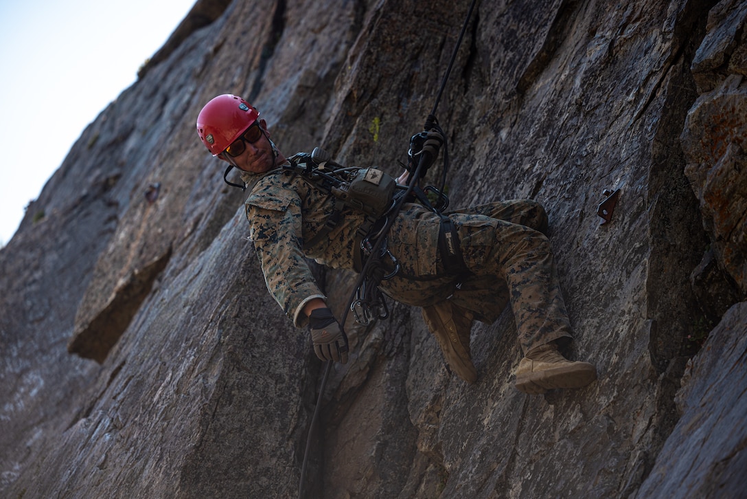 U.S. Marine Corps Staff Sgt. Joshua Amidon, a Medford, Oregon native, Mountain Warfare Instructor with Mountain Warfare Training Center, Marine Air-Ground Task force Training Command, demonstrates rappelling techniques as part of Mountain Exercise 5-24 at MCMWTC, Bridgeport, California, Aug. 1, 2024. MTX is a month-long exercise designed to better prepare units to survive and operate effectively in austere, mountainous terrain. (U.S. Marine Corps photo by Lance Cpl. Iris Gantt)