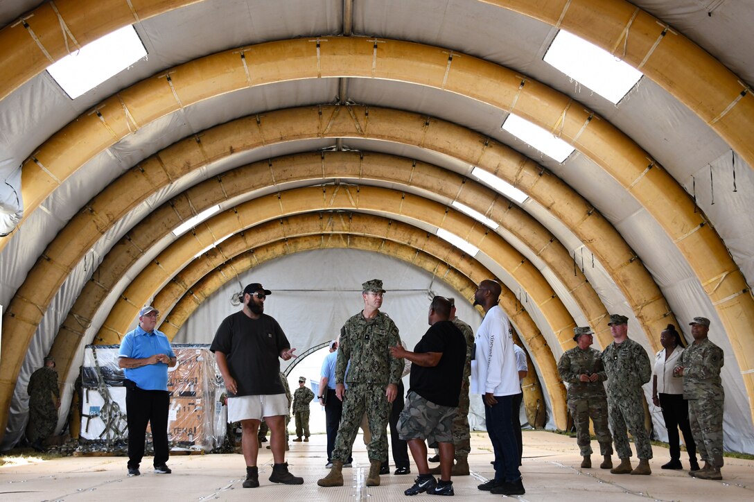 A group of people standing in a large tent
