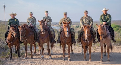 Capt. Elizabeth Mead is shown with her Soldiers on a trail ride with the U.S. Border Patrol. The trail ride was awarded to the Soldiers for doing an outstanding job in helping the U.S. Border Patrol.