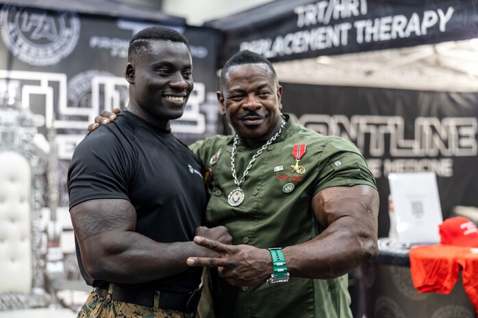 U.S. Marine Corps Sgt. Kofi Boateng Jr., left, a recruiter with Recruiting Sub Station Memorial City, Recruiting Station Houston, poses for a photo with Andre Rush, a fitness influencer, during the American Fitness Expo at the George R. Brown Convention Center in Houston, Texas, Aug. 3, 2024. The Marines held a recruiting booth alongside fitness influencers, health vendors; and professional athletes to challenge attendees and vendors alike in a pull-up bar challenge. (U.S. Marine Corps photo by Sgt. Ryan H. Pulliam)