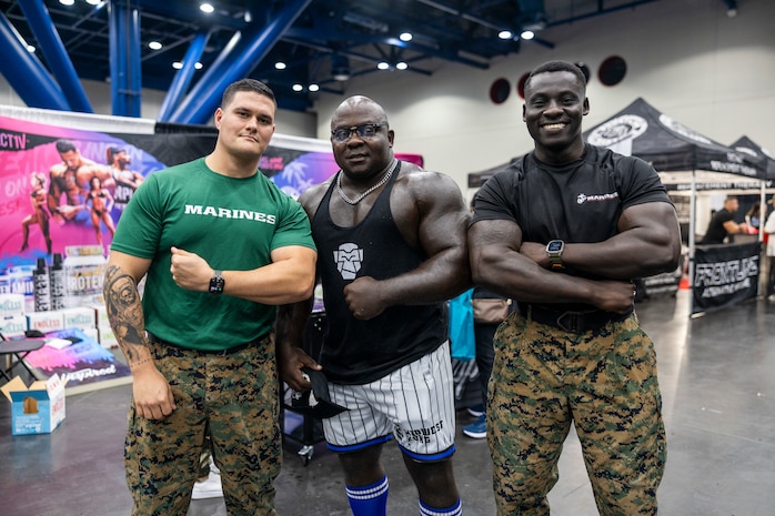 From left, U.S. Marine Corps Gunnery Sgt. Alex Rojas, a recruiter with the Recruiting Station Houston officer selection team, 8th Marine Corps District; Brandon Copeland, a fitness influencer; and Sgt. Kofi Boateng Jr., a recruiter with Recruiting Sub Station Memorial City, RS Houston; pose for a photo during the American Fitness Expo at the George R. Brown Convention Center in Houston, Texas, Aug. 3, 2024. The Marines held a recruiting booth alongside fitness influencers, health vendors; and professional athletes to challenge attendees and vendors alike in a pull-up bar challenge. (U.S. Marine Corps photo by Sgt. Ryan H. Pulliam)