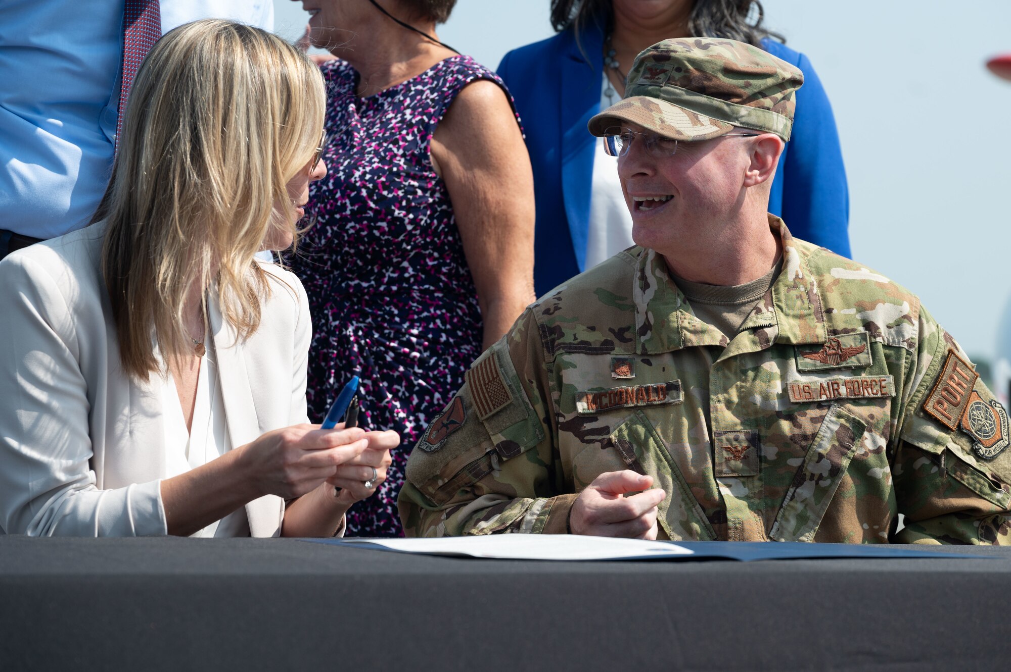 U.S. Air Force Col. Chris McDonald, 436th Airlift Wing commander, right, speaks with Nicole Majeski, 11th Secretary of the Delaware Department of Transportation, during the Joint Use Agreement signing ceremony at Dover, Delaware, Aug. 15, 2024. This agreement allows the use of Dover AFB's flying facilities by the Delaware Department of Transportation for approved civilian and commercial flights. (U.S. Air Force photo by Senior Airman Dieondiere Jefferies)