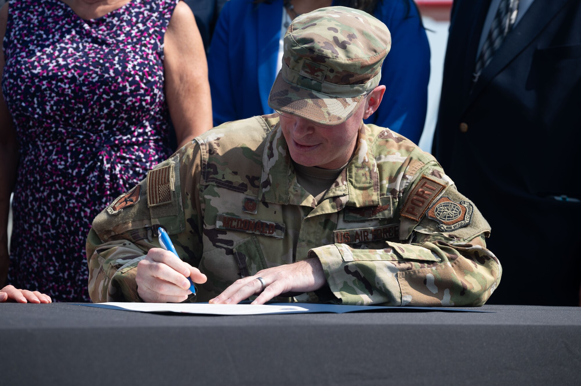 U.S. Air Force Col. Chris McDonald, 436th Airlift Wing commander, signs the Joint Use Agreement at Dover, Delaware, Aug. 15, 2024. This agreement allows the use of Dover AFB's flying facilities by the Delaware Department of Transportation for approved civilian and commercial flights. (U.S. Air Force photo by Senior Airman Dieondiere Jefferies)