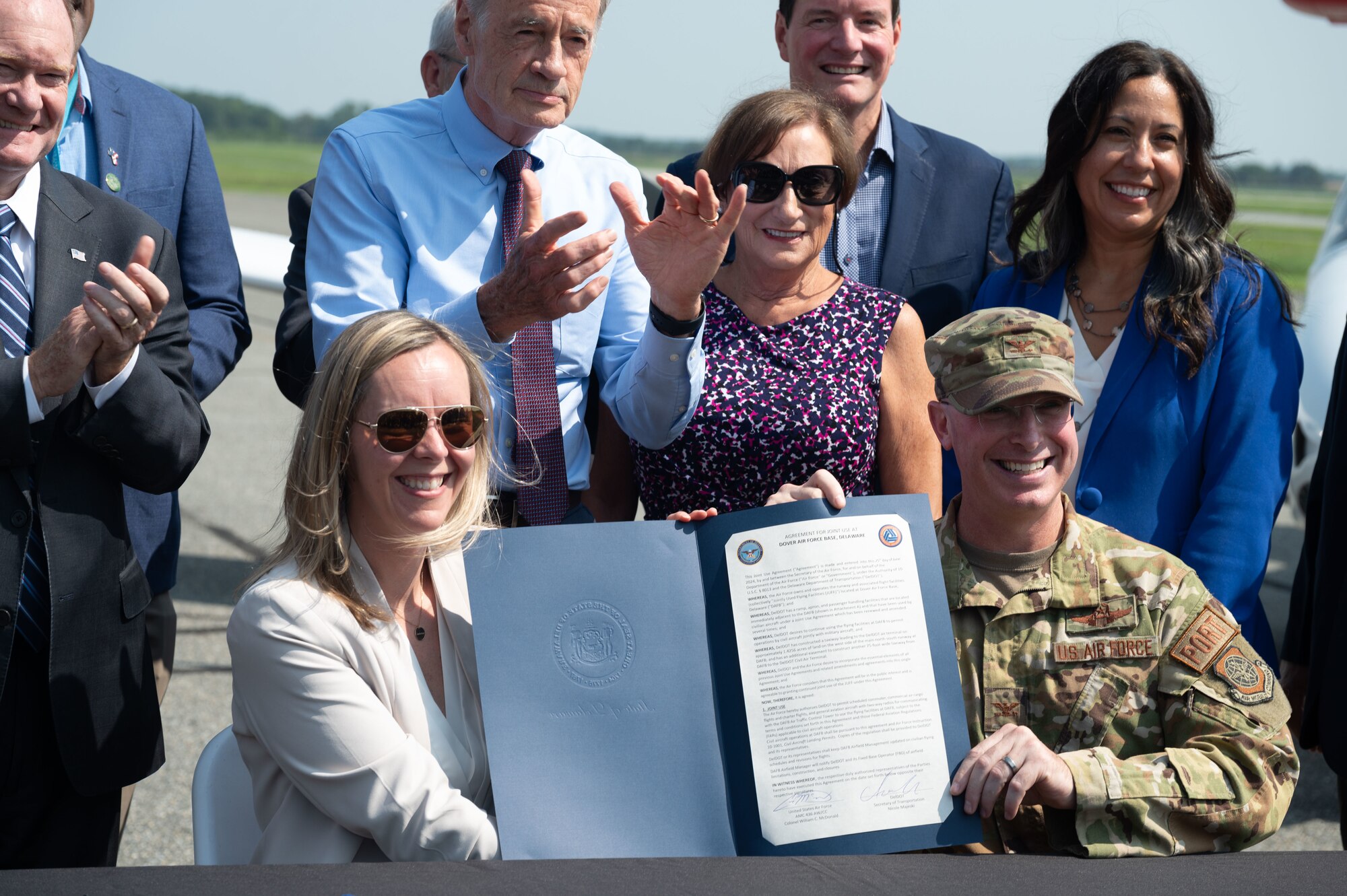 Nicole Majeski, 11th Secretary of the Delaware Department of Transportation, left, and U.S. Air Force Col. Chris McDonald, right, 436th Airlift Wing commander, pose with the signed Joint Use Agreement. This agreement allows the use of Dover AFB's flying facilities by the Delaware Department of Transportation for approved civilian and commercial flights. (U.S. Air Force photo by Senior Airman Dieondiere Jefferies)