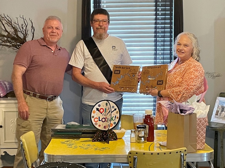Navigation Facilities Manager for the East Tennessee River Area Matt Emmons (Left) presents Gary and Judi Fleeman with retirement mementos July 31, 2024, during their retirement celebration in Lenoir City, Tennessee. They retired from the U.S. Army Corps of Engineers Nashville District with a combined 51 years of federal government service supporting the navigation mission on the Cumberland and Tennessee Rivers. (USACE Photo by Melissa Kear)