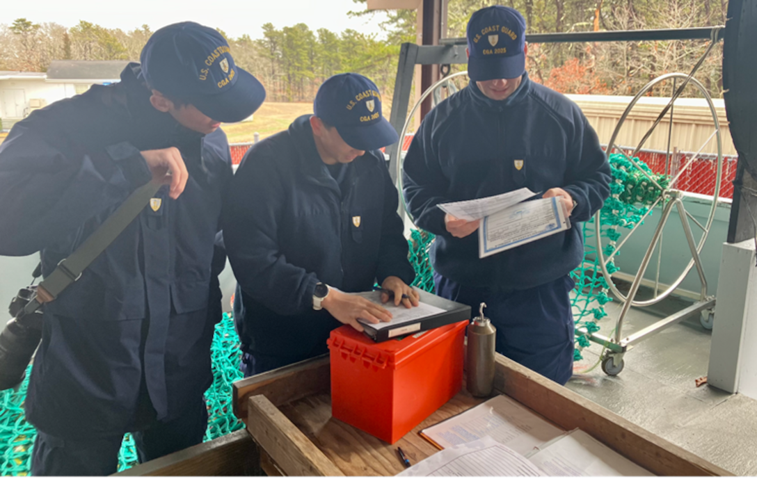 Coast Guard members review paperwork.