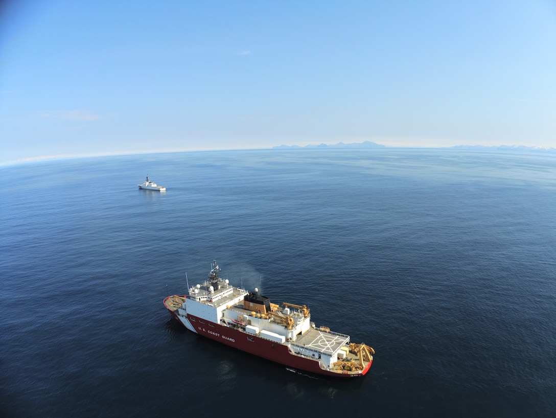 USCGC Healy (WAGB 20) steams alongside USCGC Kimball (WMSL 756) near Unimak Pass, Alaska, July 3, 2024. Healy, a polar icebreaker, and Kimball, a national security cutter, patrol the waters around Alaska to maintain maritime safety, security, and stability in the region. U.S. Coast Guard photo by Chief Warrant Officer Brian Williams.