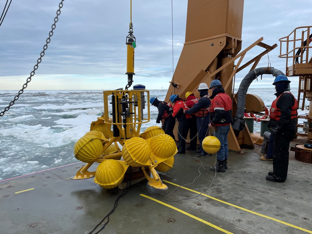 Members of the U.S. Coast Guard Cutter Healy (WAGB 20) deck department and the embarked science party aboard Healy deploy a subsurface mooring in the Beaufort Sea, July 14, 2024. This mooring is equipped with multiple sensors that collect oceanographic data pertaining to the physical, chemical, and biological properties of the Arctic Ocean. U.S. Coast Guard photo.