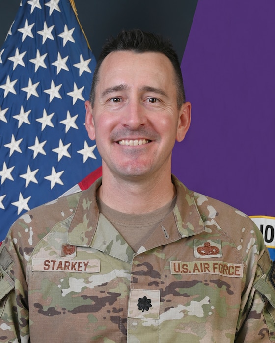 A photo of an Airmen smiling.