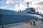 GARDEN ISLAND, Western Australia, Australia (Aug. 16, 2024) – Military Sealift Command civil service mariners assigned to the submarine tender USS Emory S. Land (AS 39) throw a heaving line from the ship to Royal Australian Navy sailors on the pier as the Emory S. Land moors at HMAS Stirling, Western Australia, Australia, Aug. 16. HMAS Stirling is Emory S. Land’s seventh port call since it departed on deployment May 17. Emory S. Land is on deployment supporting the U.S. 7th Fleet, the U.S. Navy’s largest forward deployed numbered fleet, operating with allies and partners in preserving a free and open Indo-Pacific region. Emory S. Land provides expeditionary intermediate-level maintenance, services, and logistics support to deployed submarines. (U.S. Navy photo by Mass Communication Specialist 2nd Class Darek Leary)