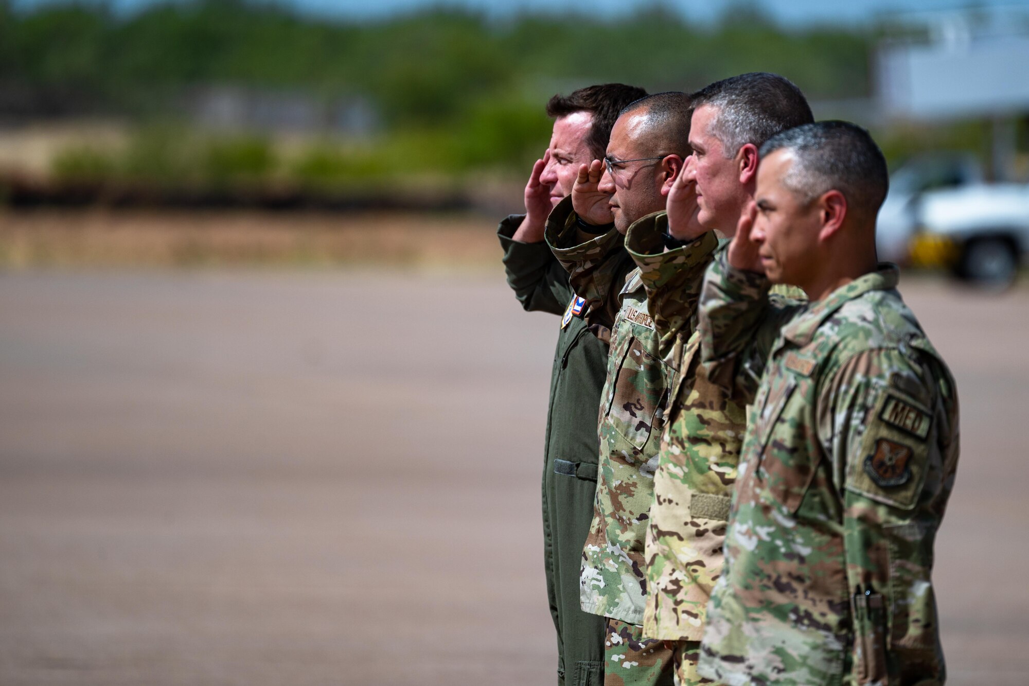 Leadership from the 317th Airlift Wing and the 7th Bomb Wing salute the arrival of U.S. Air Force Maj. Gen. Charles Bolton, 18th Air Force commander, at Dyess Air Force Base, Texas, Aug. 13,  2024. Bolton’s visit was aimed at meeting the outstanding Airmen of Dyess AFB. (U.S. Air Force photo by Airman 1st Class Jade M. Caldwell)
