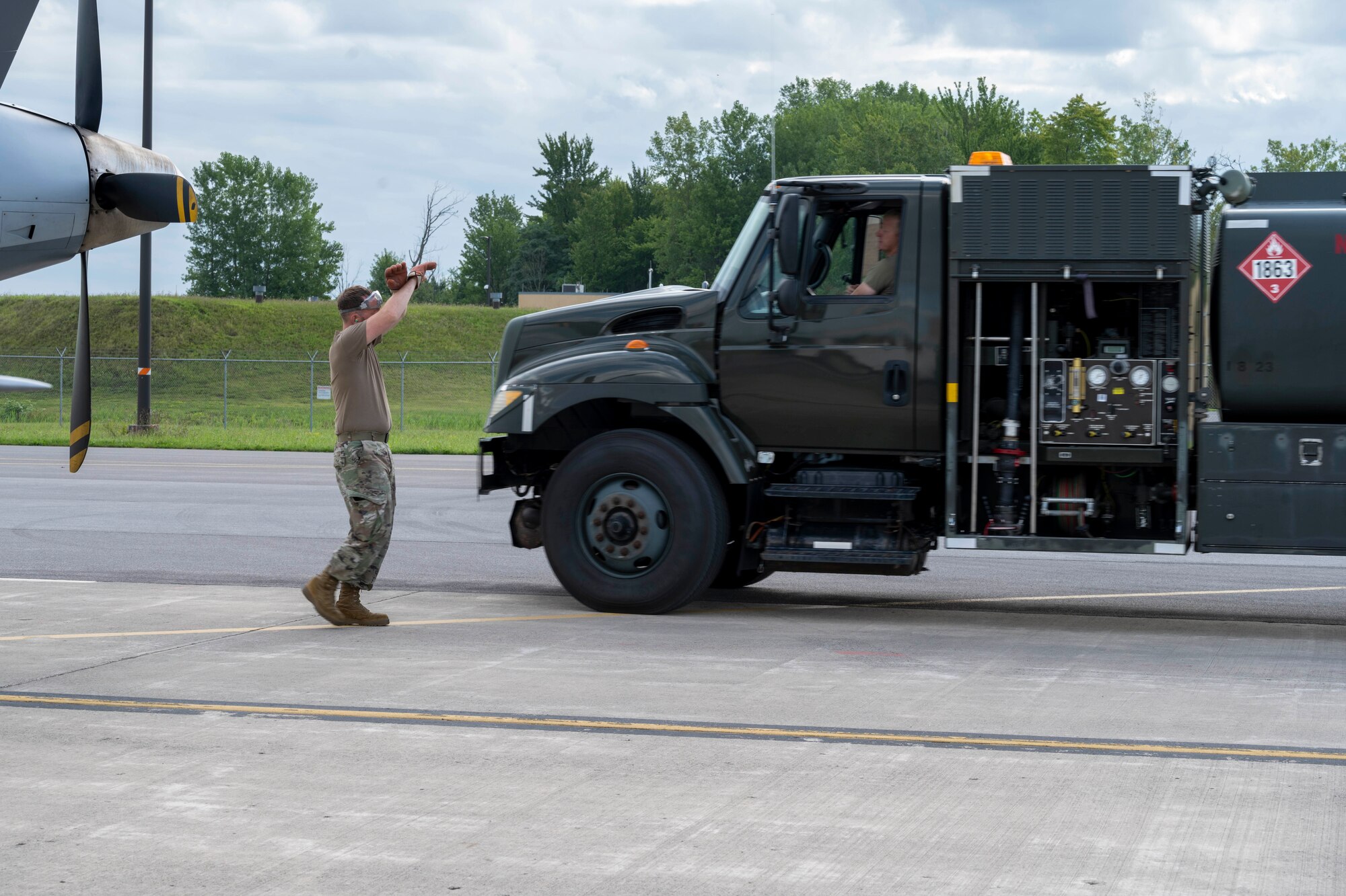 U.S. Air Force Senior Airman Bryan Stanley, 491st Attack Squadron MQ-9 Reaper dedicated crew chief, directs a fuel truck at Hancock Field Air National Guard Base, New York, Aug. 12, 2024.