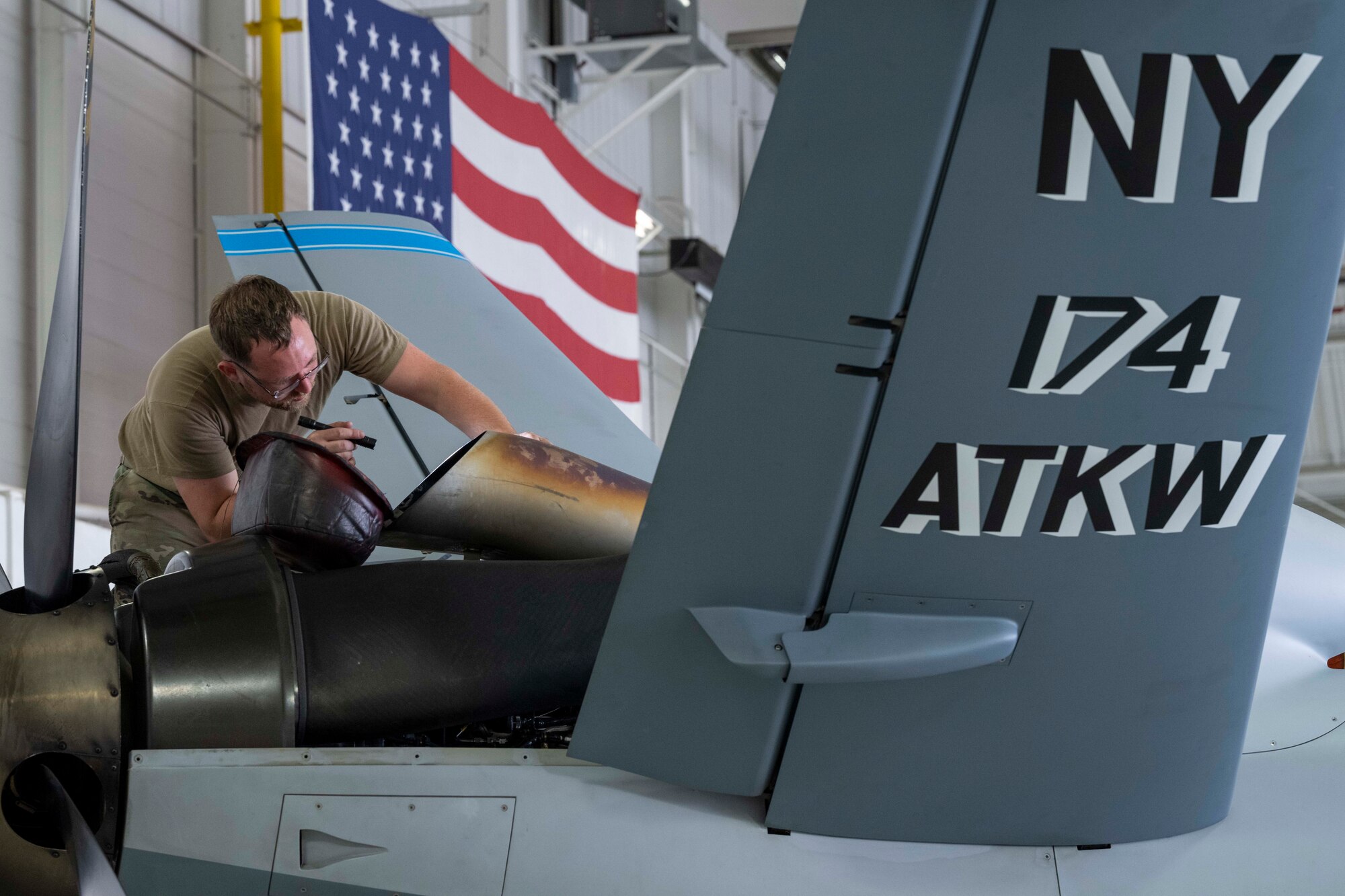U.S. Air Force Senior Airman Bryan Stanley, 491st Attack Squadron MQ-9 Reaper dedicated crew chief, performs maintenance on an MQ-9 at Hancock Field Air National Guard Base, New York, Aug. 12, 2024.