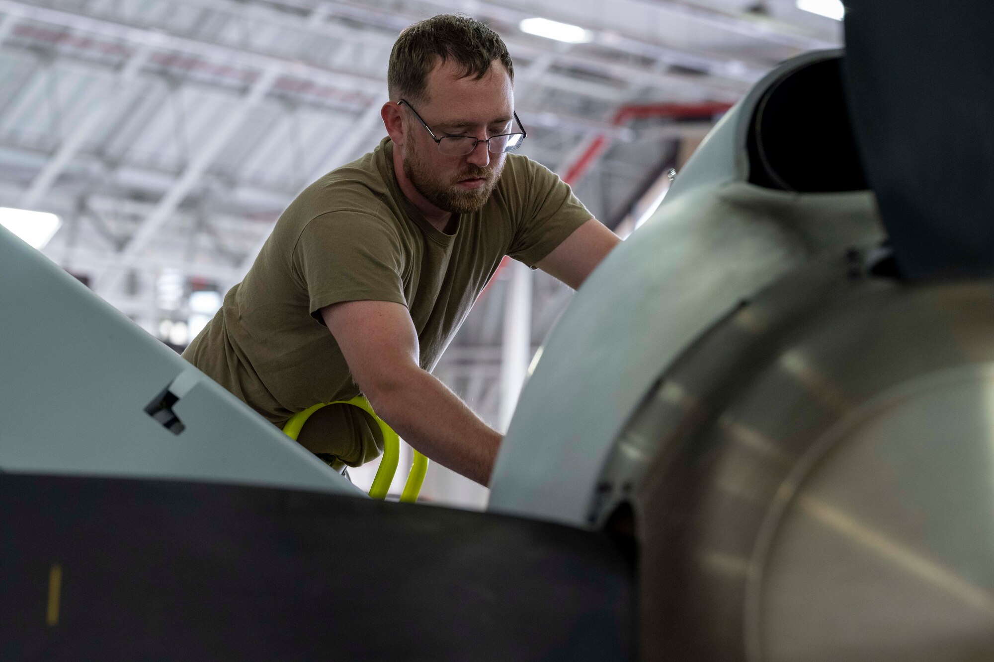 U.S. Air Force Senior Airman Bryan Stanley, 491st Attack Squadron MQ-9 Reaper dedicated crew chief, performs maintenance on an MQ-9 at Hancock Field Air National Guard Base, New York, Aug. 12, 2024.