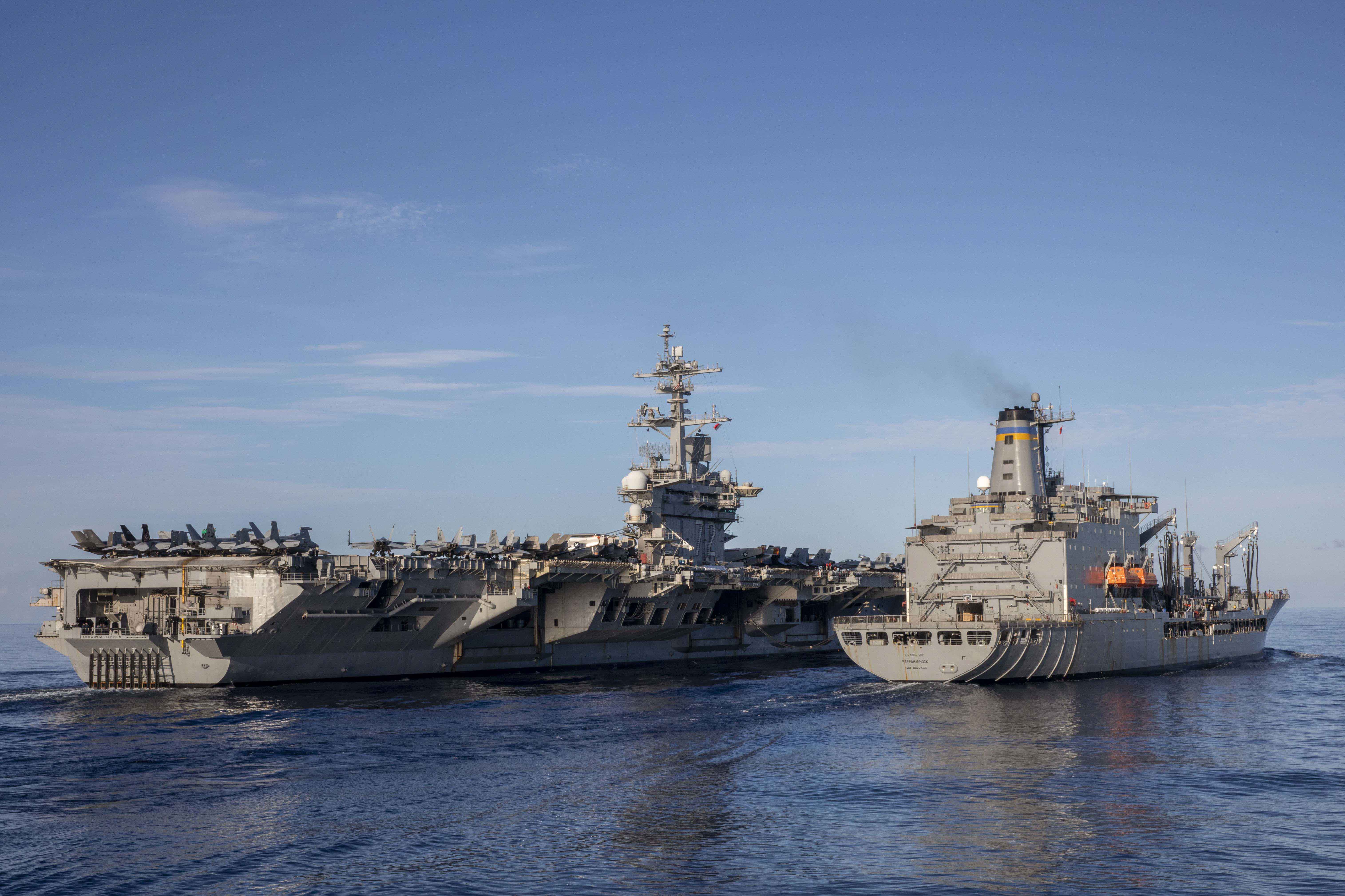 USS Abraham Lincoln (CVN 72) conducts a replenishment-at-sea with USNS Rappahannock (T-AO 204) in the South China Sea.