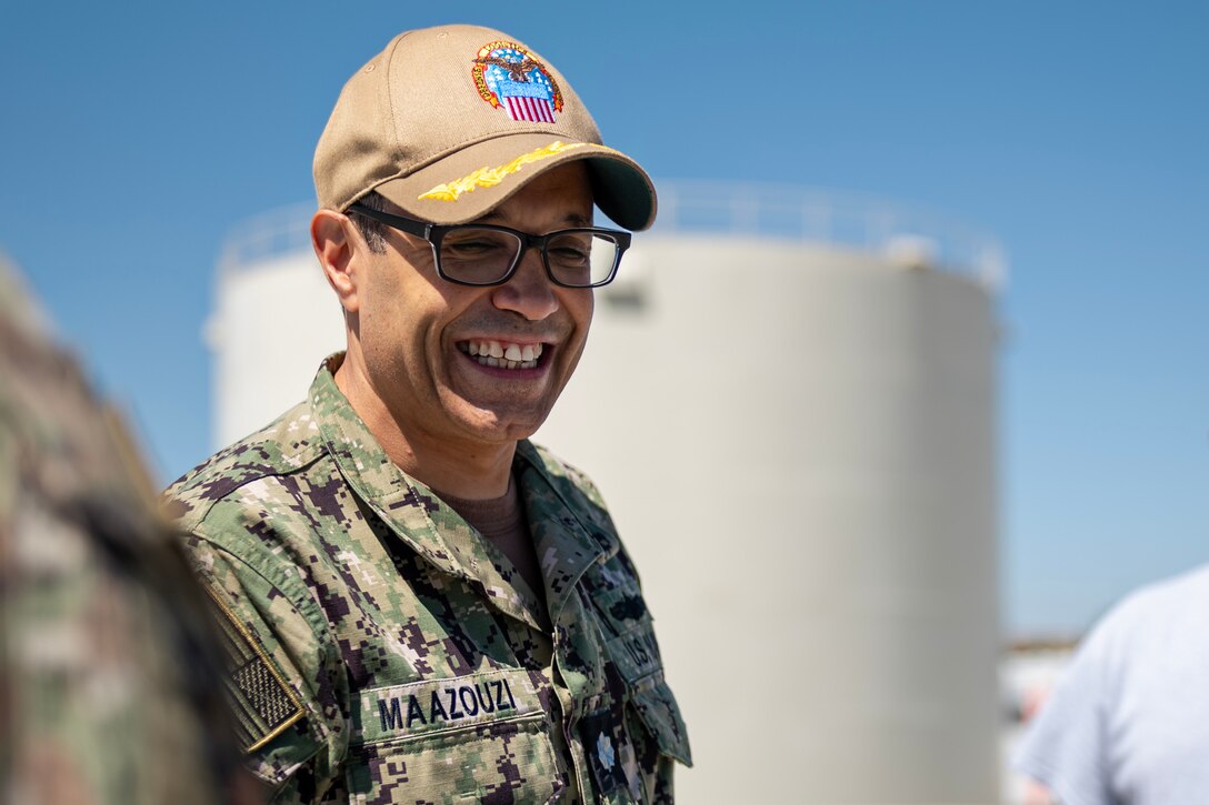 U.S. Navy Cmdr. Anas E. Maazouzi, Defense Logistics Agency Energy – Americas West commander, laughs after making a joke while touring a fuel facility at Fairchild Air Force Base, Washington, July 31, 2024. The 92nd Logistics Readiness Squadron is comprised of 60 fuels professionals who operate all fuel infrastructures on base. DLA-E plays a critical role in supporting the Department of Defense by ensuring a reliable supply of fuel and energy resources by managing the procurement, storage, and distribution of aviation fuel, ground fuel, and other energy products necessary for the operation of aircraft and base facilities. (U.S. Air Force photo by Senior Airman Morgan St Marks)