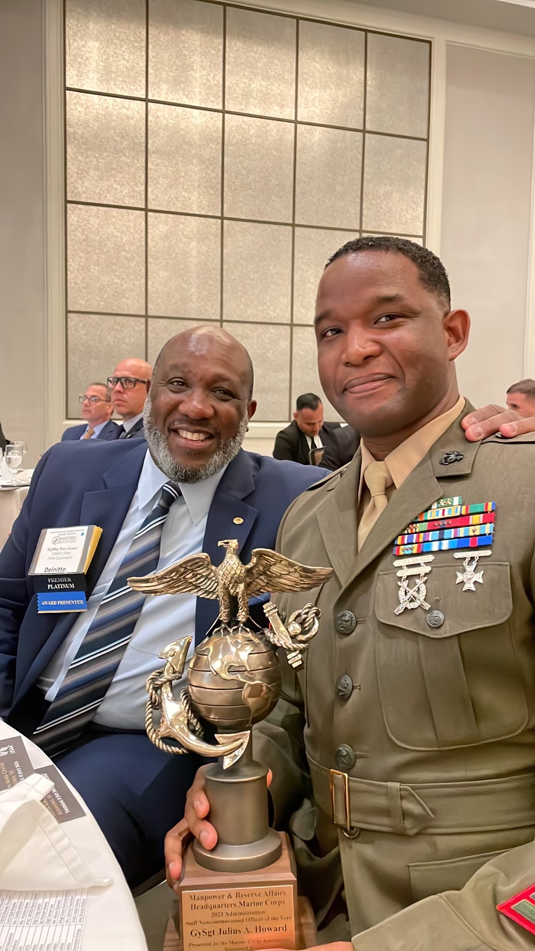 U.S Marine Corps Gunnery Sergeant Julius A. Howard, right, and Sgt. Maj. Ronald Green (retired) smile during the Deputy Commandant for Manpower and Reserve Affairs Awards dinner in Alexandria, Virginia, July 11, 2024.  Howard received the 2023 Administration Staff Non-commissioned Officer of the Year Award. Howard, a native of Cherry Point, North Carolina, is the Manpower and Personnel Chief for 3d Marine Division.