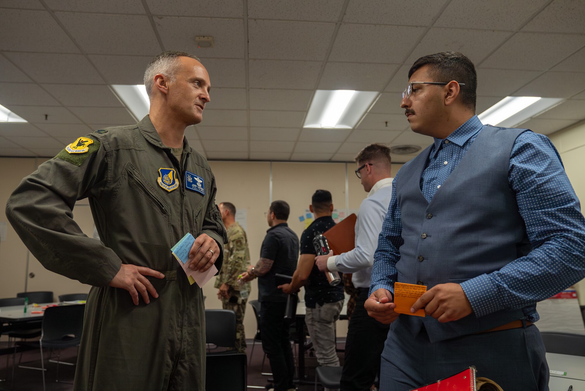 Col. Lundeby conversing with an Airman attending Project Mercury workshop