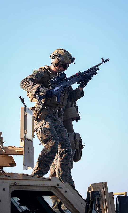 A U.S. Marine with Battalion Landing Team 1/8, 24th Marine Expeditionary Unit (MEU) Special Operations Capable (SOC), carries a M240B machine gun during a crew served weapons range aboard the Harpers Ferry-class dock landing ship USS Oak Hill (LSD 51), while underway in the Mediterranean Sea, Aug. 14, 2024. The Wasp Amphibious Ready Group-24th MEU (SOC) is on a scheduled deployment to U.S. Naval Forces Europe and Africa area of operations to support U.S., Allied and partner interests in the region, including in the Eastern Mediterranean Sea, and to continue promoting regional stability and deterring aggression. (U.S. Marine Corps photo by Sgt. Jacqueline Peguero-Montes)