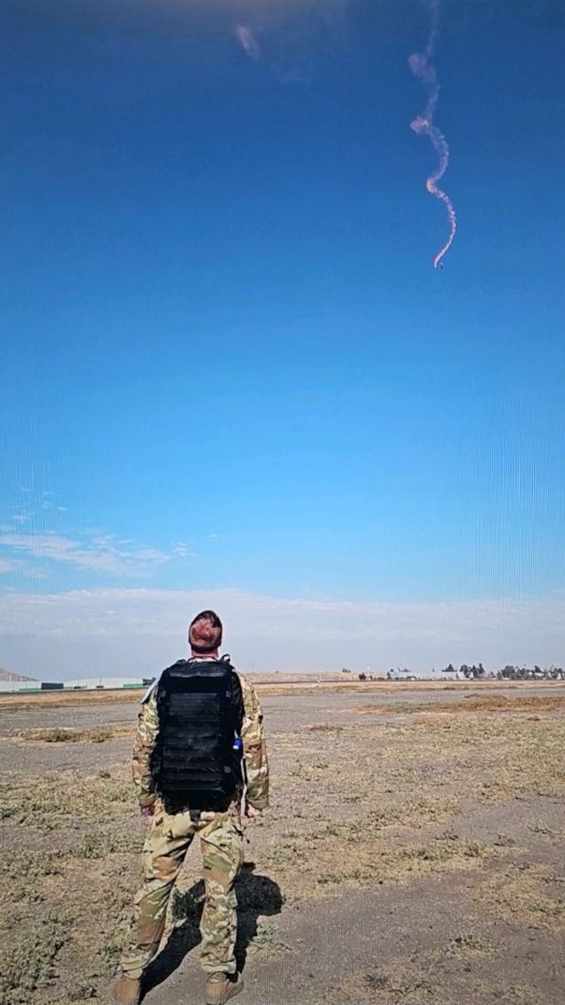 U.S. Air Force Maj. Michael Jensen, 355th Medical Group aeromedical nurse practitioner, watches a parachute exercise during the Feria Internacional del Aire y del Espacio (FIDAE), an international air and space show, at Pudahuel Air Base, Chile, April 13, 2024. Jensen provided medical care for multiple squadrons during FIDAE. (Courtesy Photo)