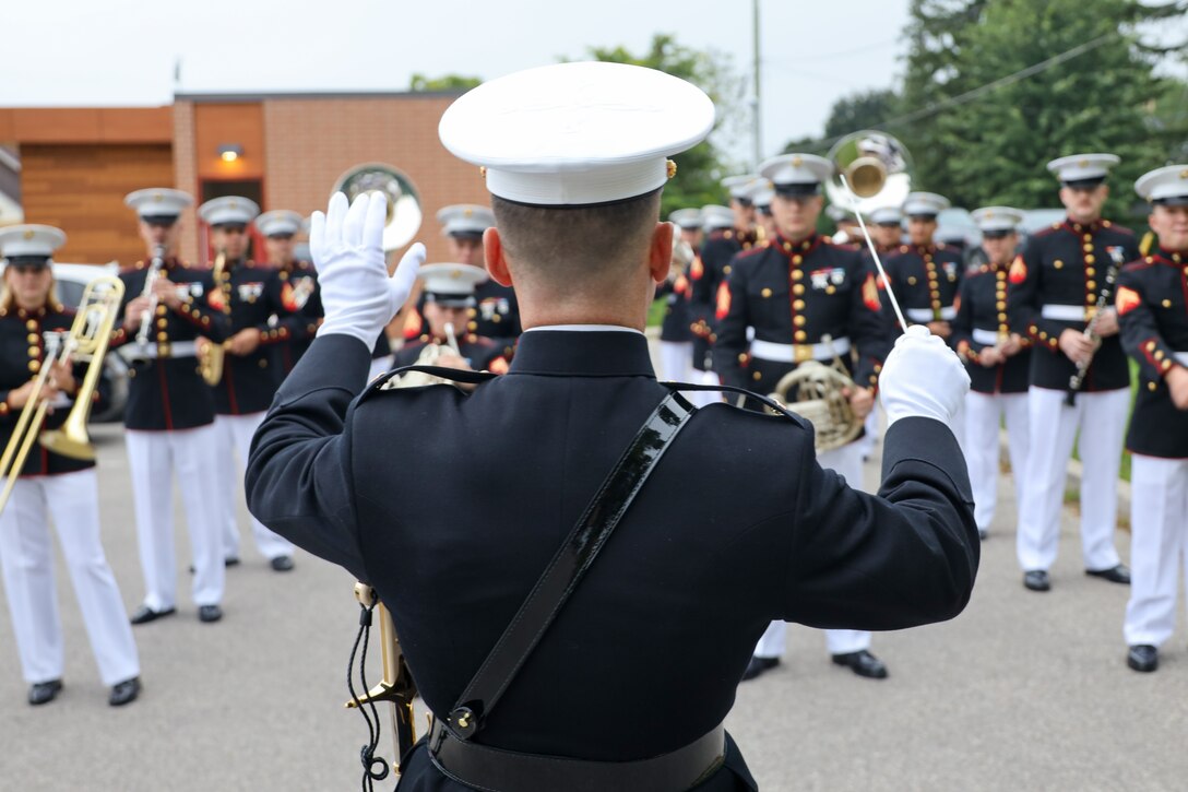 U.S. Marine Corps Chief Warrant Officer 2 Nathan Doggett, center, a native of Illinois and the director of the 2nd Marine Aircraft Wing (MAW) Band, conducts sound checks prior to the opening parade of the Fergus Scottish Festival & Highland Games in Ontario, Canada, Aug. 8, 2024. The Fergus Scottish Festival & Highland Games is an annual three-day event celebrating local Scottish heritage through various forms of entertainment. The 2nd MAW Band will be performing during the festival to strengthen community relationships and reaffirm the history, customs, and traditions represented by the United States Marine Corps. (U.S. Marine Corps photo by Staff. Sgt. Theodore Bergan)