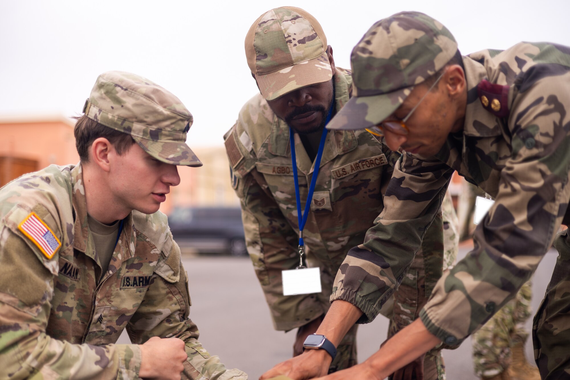 U.S. Army Sgt. Caleb Nawman and U.S. Air Force Staff Sgt. Arnaud Agbo complete a detailed inventory inspection with their Morrocan counterparts Aug. 15, 2024, at Agadir, Morocco. Agbo volunteered for Arcane Thunder 24 through the U.S. Air Force Language Enabled Airman Program. Arcane Thunder 24 marked a significant advancement in multi-domain operations and partnership between the U.S. and Morocco. Approximately 300 service members from the U.S., Morocco, the United Kingdom and Germany, took part in Exercise Arcane Thunder 24 from Aug. 5 to Aug. 16 in Germany and Morocco. The exercise will build on Morocco and U.S. strong and strategic relationship to ensure that partner forces are equipped with the capability to synchronize and employ non-lethal effects across all domains against adversaries.  (U.S. Army photo by Staff Sgt. Rene Rosas)