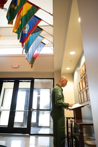 Maj. Gen. Fábio Luis Morau, Brazilian Defense and Air Attaché, signs a guestbook at the 318th Training Squadron at JBSA-Lackland, Texas, Aug. 7, 2024.