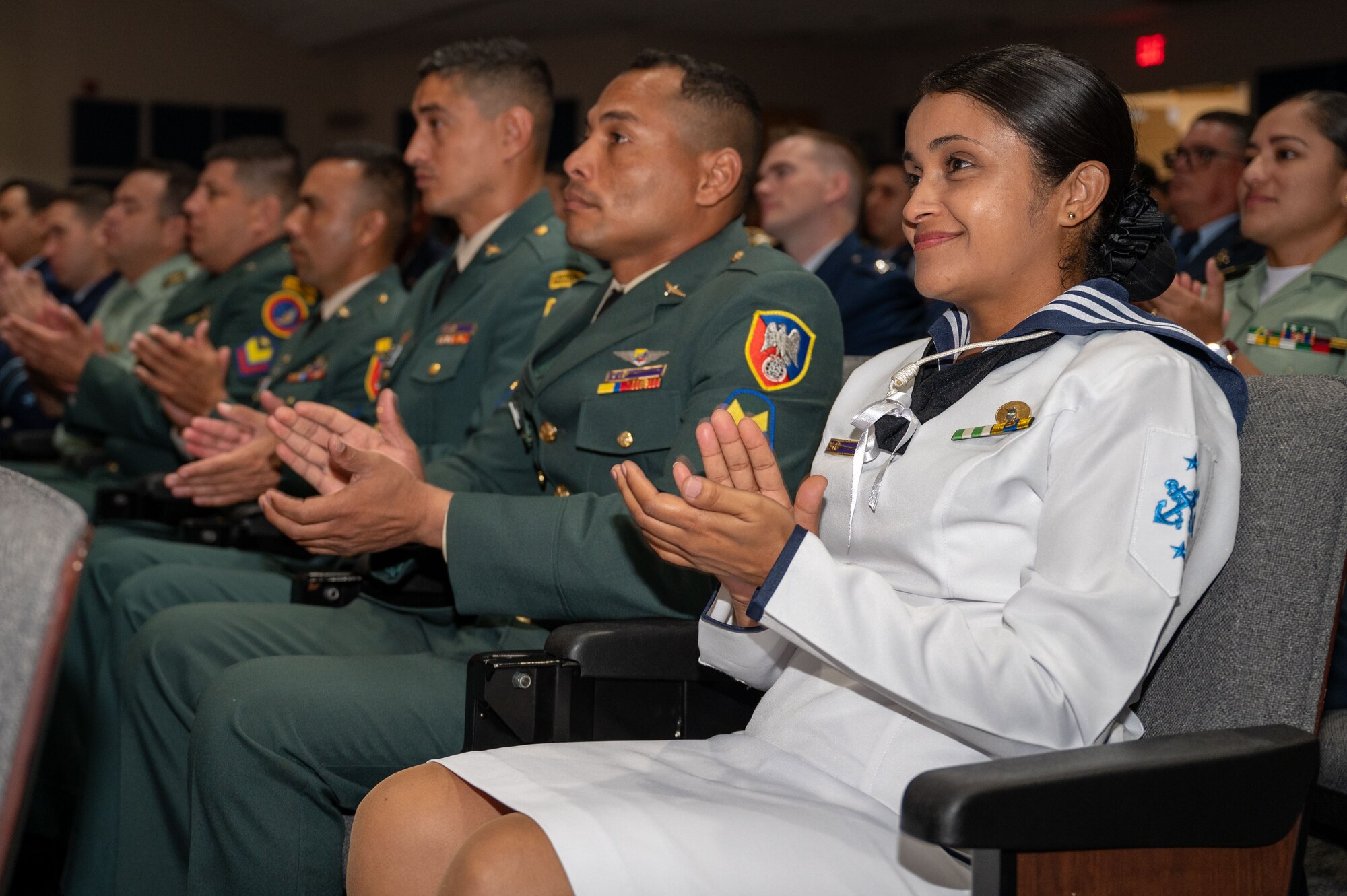 International military students clap during a graduation ceremony for the Inter-American Air Forces Academy at JBSA-Lackland, Texas, Aug. 7, 2024.
