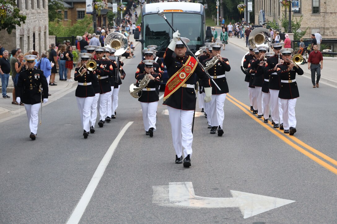 U.S. Marines with the 2nd Marine Aircraft Wing (MAW) Band march during the opening parade of the Fergus Scottish Festival & Highland Games in Ontario, Canada, Aug. 8, 2024. The Fergus Scottish Festival & Highland Games is an annual three-day event celebrating local Scottish heritage through various forms of entertainment. The 2nd MAW Band will be performing during the festival to strengthen community relationships and reaffirm the history, customs, and traditions represented by the United States Marine Corps. (U.S. Marine Corps photo by Staff. Sgt. Theodore Bergan)
