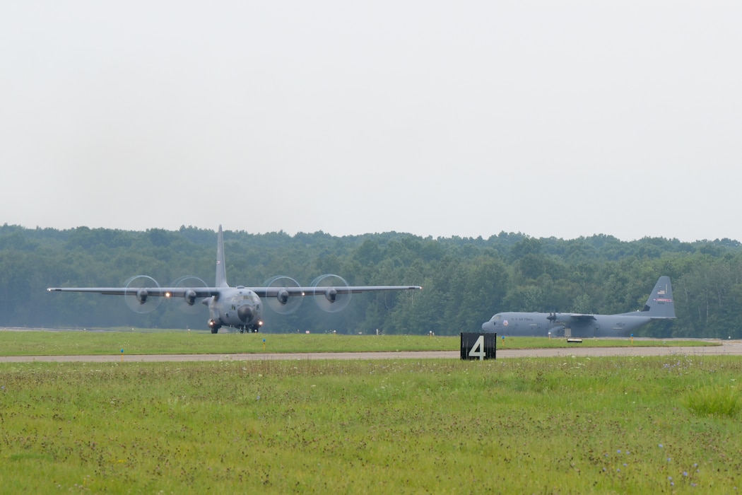 A C-130H Hercules aircraft takes off at Youngstown Air Reserve Station while the 910th Airlift Wing's new C-130J Super Hercules aircraft awaits its turn to take off for its maiden flight as the Wing's newest aircraft, Aug. 16, 2024.