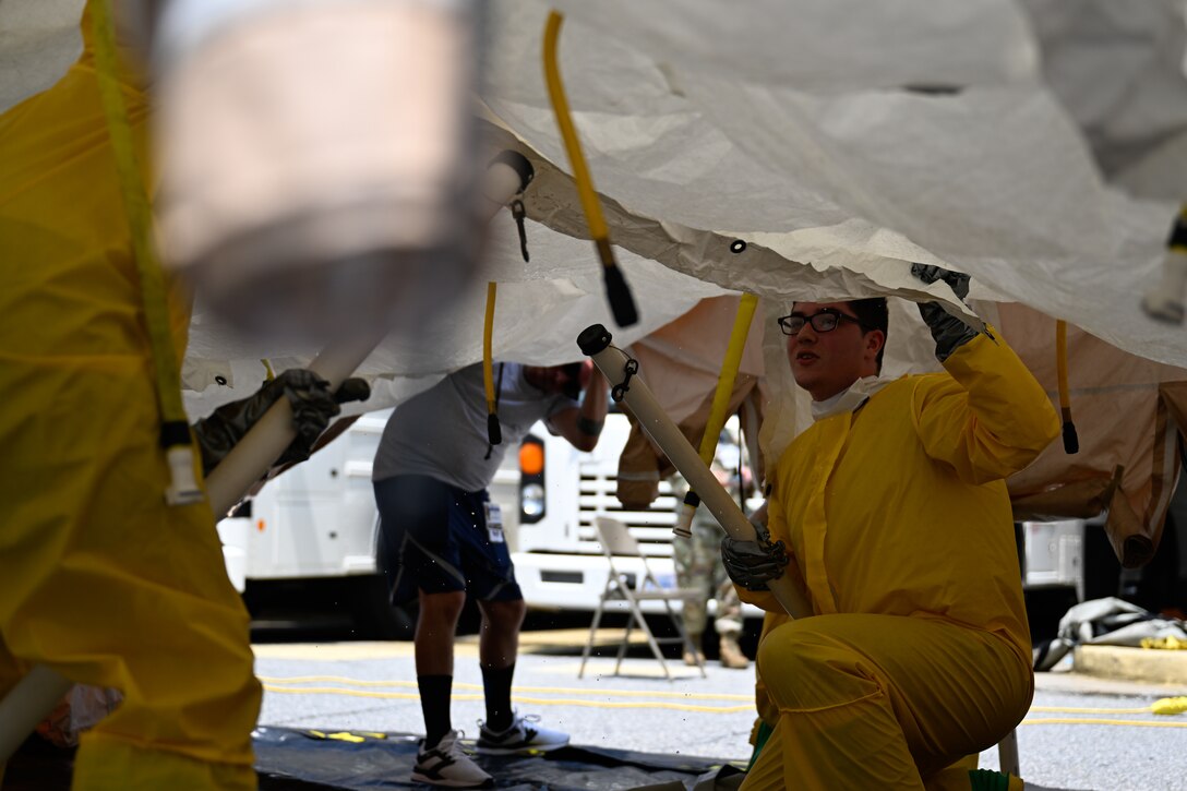 Airmen set up a decontamination tent for a decontamination exercise.