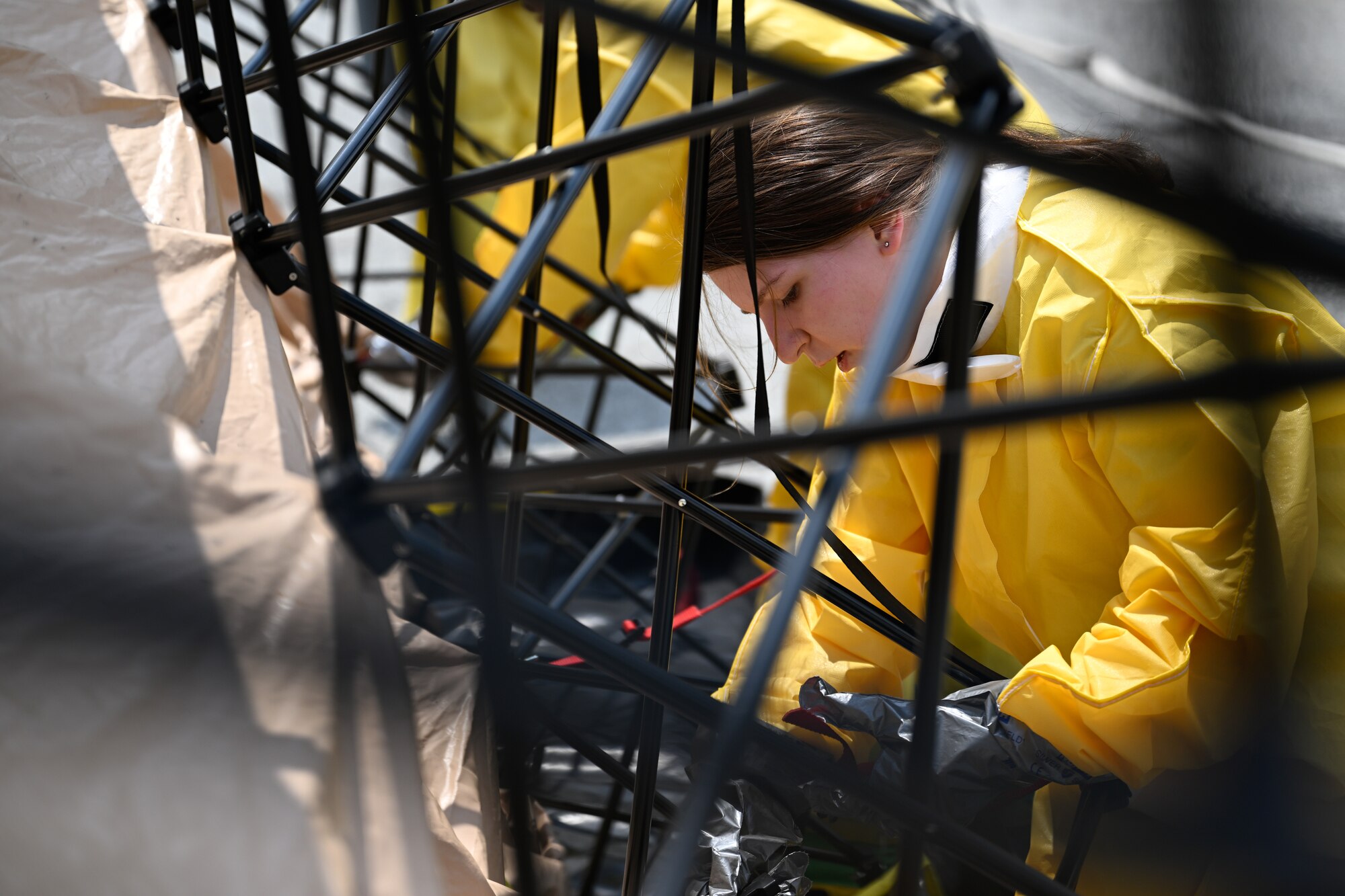 Airmen assemble a decontamination tent during a decontamination exercise.