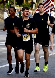 Soldiers running with a flag.