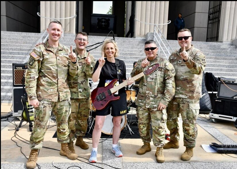 Soldiers posing with musical insturments.